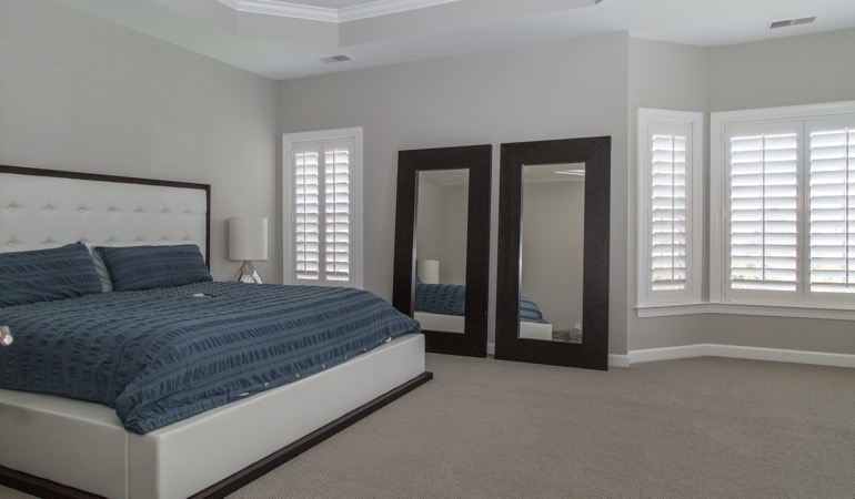 White shutters in a minimalist bedroom in Hartford.